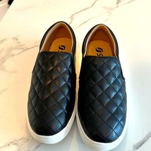 Black slip on sneakers, size 7.